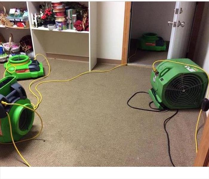 green drying equipment set up on wet carpet