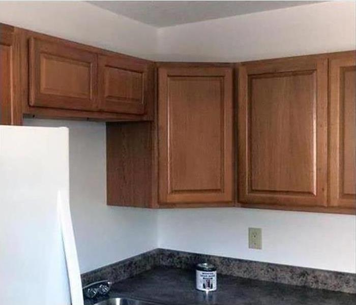a kitchen with brown cabinets 