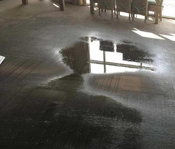 water on the carpet of an office 