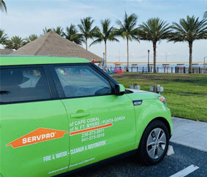 green SERVPRO truck parked by the beach