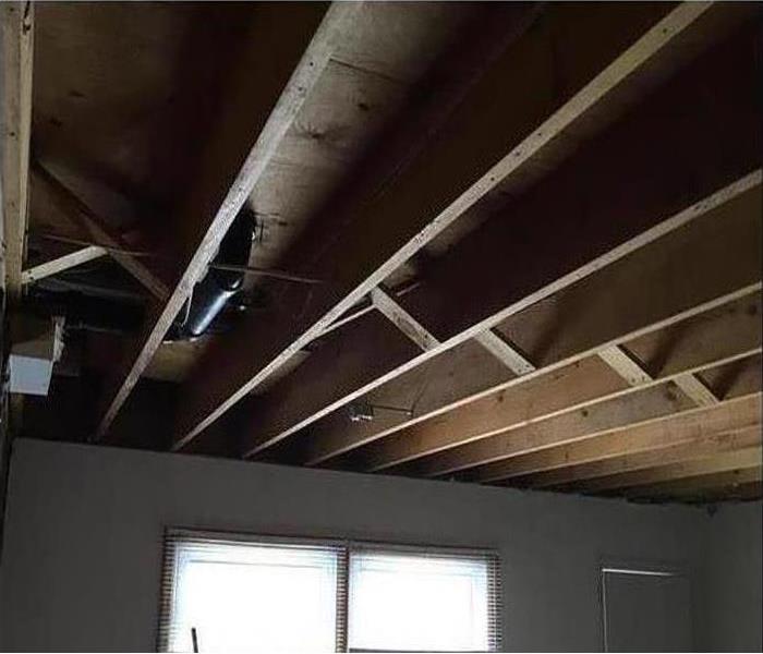 a ceiling with no sheetrock and exposed beams